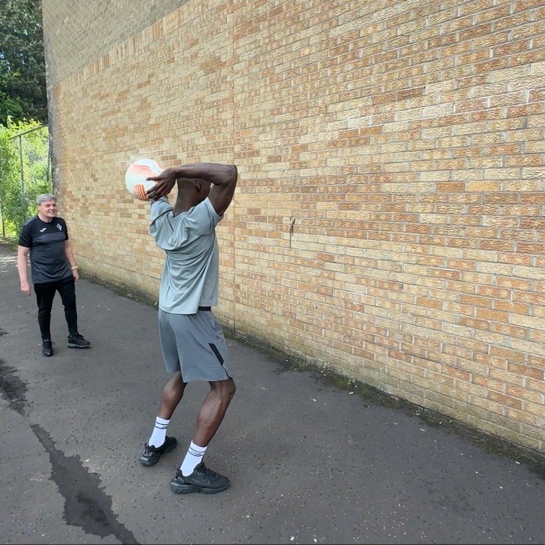 Player training with Long Throw Coach heavy ball