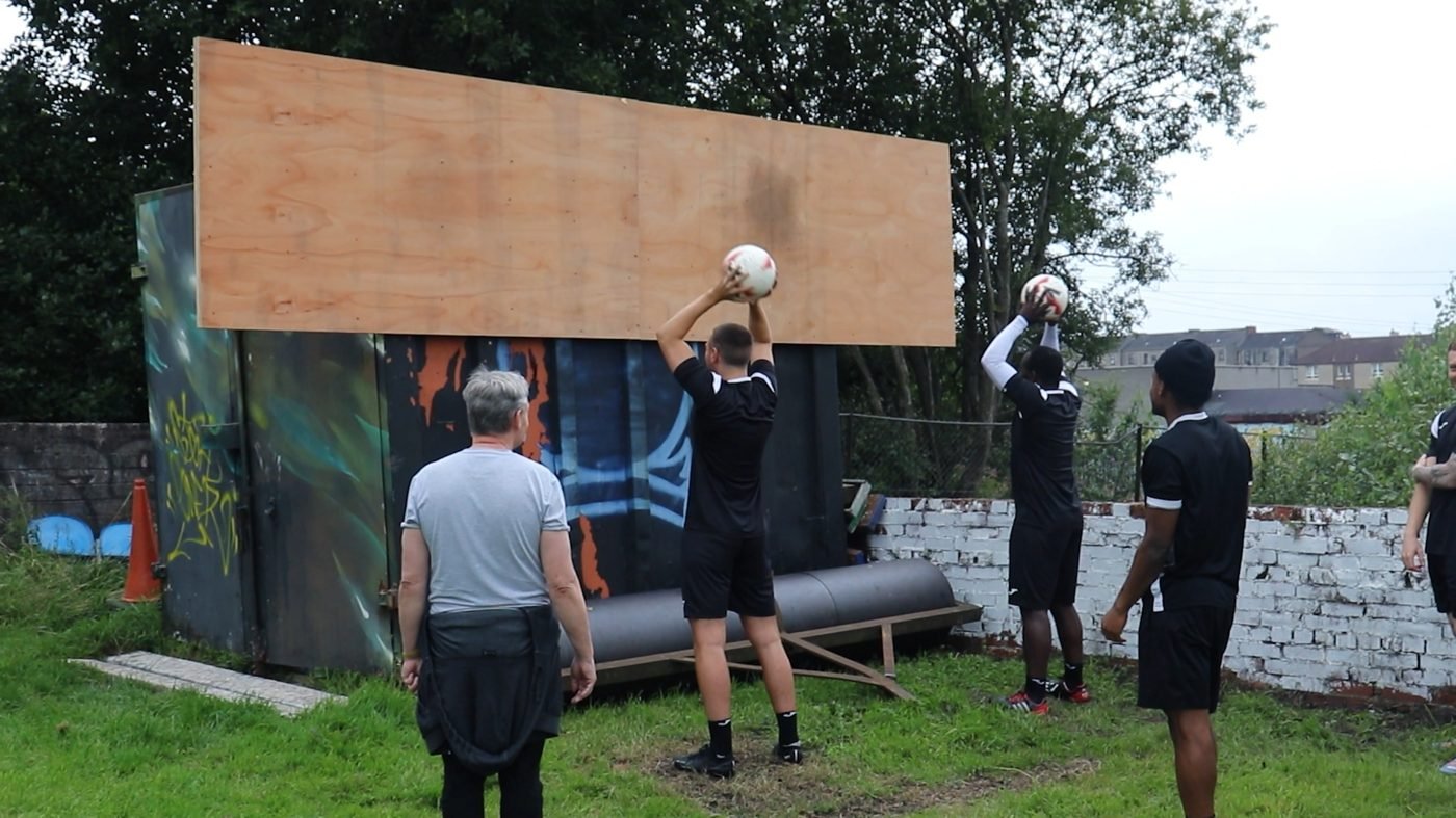 Players doing heavy ball wall throws at a Long Throw Coach session